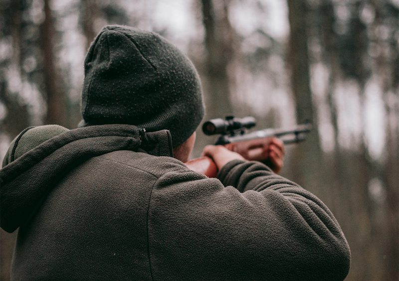 hunter target practicing in the woods