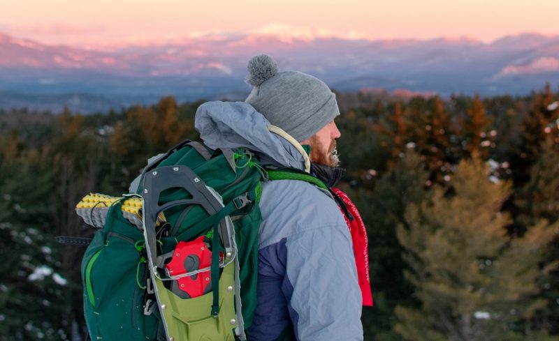 man with backpack in winter in Colorado