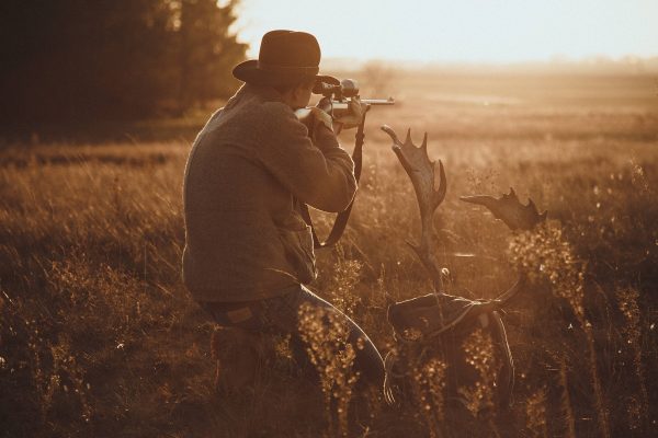 hunter in Colorado near some antlers