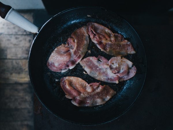 cooking in a cast iron pan with bacon