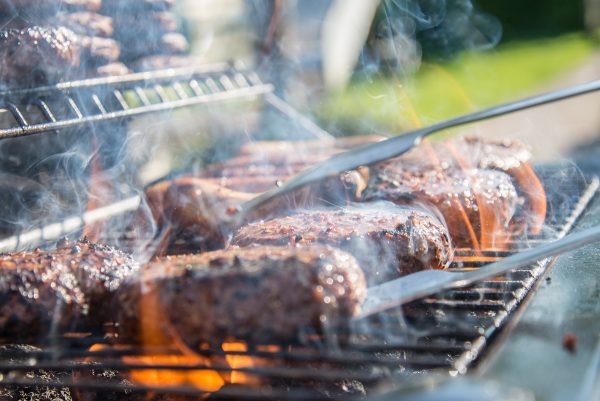 elk steaks cooking on a grill