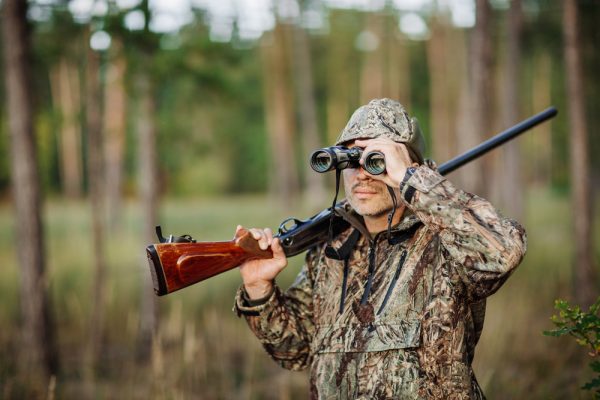 a hunter with Soap Mesa Outfitters using binoculars to hunt