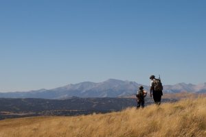 Father teaching son life lessons while out on a hunt 