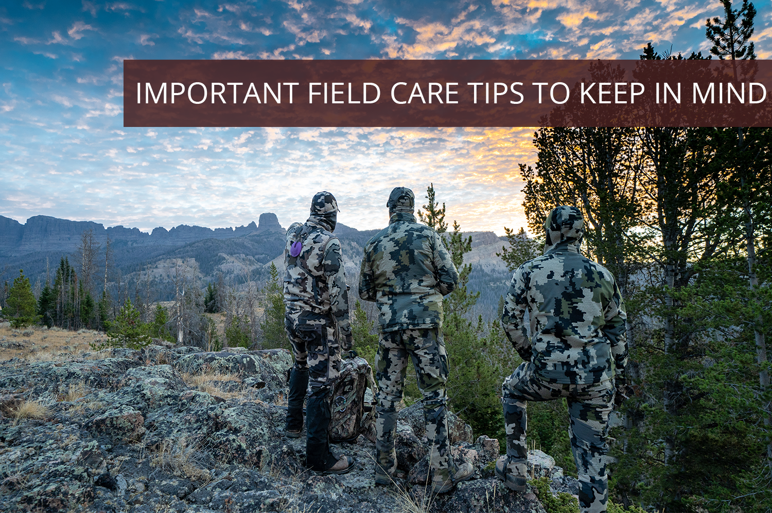 Three men in camouflage standing on a ridge during a sunset, ready to start their field care.