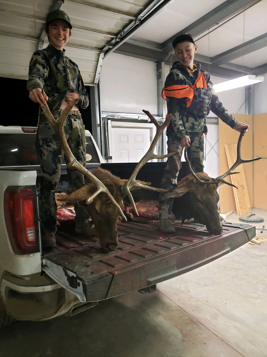 Boys showing their elk kill