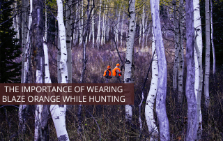 Two anonymous hunters hunting in Colorado wearing blaze orange vests.