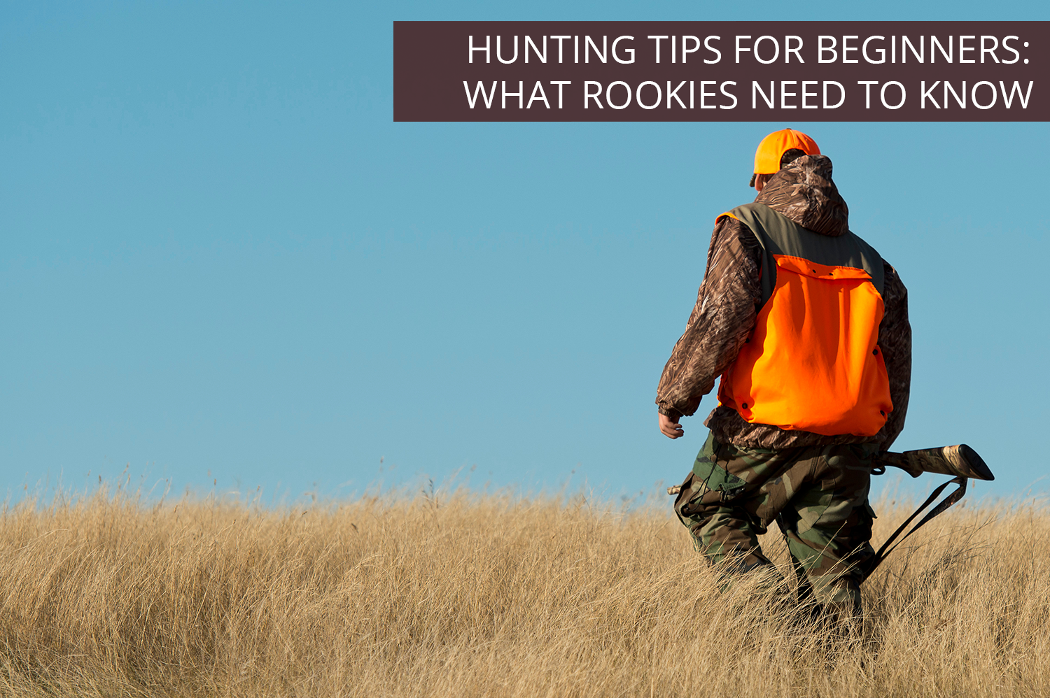 A beginner hunter on a grassy hill in an orange vest holding a rifle, ready to hear some hunting tips.