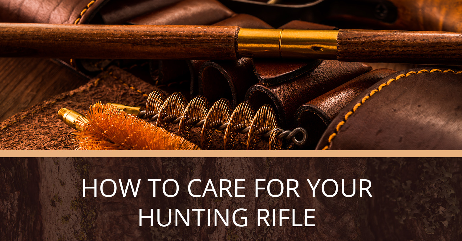 A hunting rifle sitting on a table with cleaning supplies.