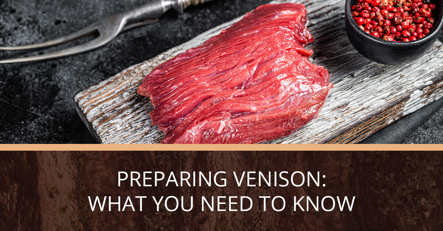 Venison steak sitting on a wood board, ready to be cooked.